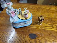 Music box with sewing mouse figure and mini mice on thread spool