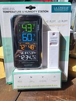 Front view of sealed retail package showing display unit and sensor