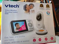 Front of retail box showing monitor and camera