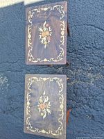 Top view showing floral marquetry on both tables