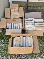 Four cartons holding multiple styrofoam-boxed collector plates