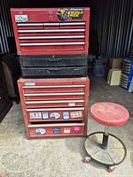 Stacked top, intermediate, and bottom Craftsman tool chests with mechanic stool