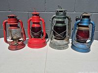 Four lanterns lined up showing color, size and overall condition