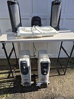 Full lot showing all six heaters on and under folding table