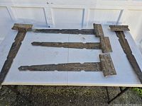 Top view showing all four 24-inch strap hinges laid out on table