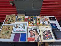 Overview of entire lot on table showing all books and magazines