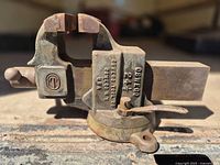 Full view of vise showing swivel base, handle and brand mark