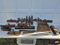 Full lot laid out on table showing all planes, file, dustpan