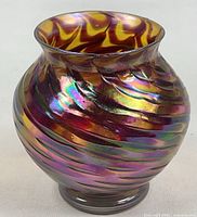 Front view of iridescent spiral ribbed vase showing shape and finish