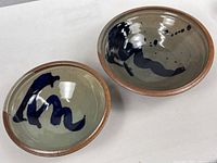 Both matched Ann Hurley stoneware bowls side by side