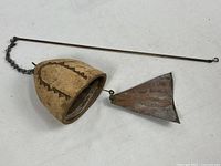 Full view of ceramic bell, copper sail, chain, and brass rod