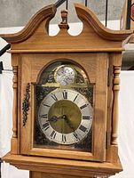 Close view of clock hood showing brass dial marked Tempus Fugit and case details