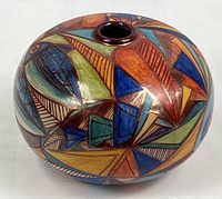 Full view of hand-painted Italian vase showing geometric pattern and gloss finish