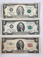 Fronts of all three $2 bills showing series years and seals