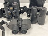 All three binoculars with straps and two cases