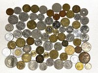 Full spread of approximately 70 assorted foreign coins