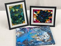 Group shot of all three abstract paintings: two framed, one stretched canvas