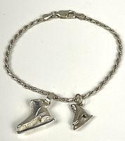 Full view of bracelet showing rope chain, clasp, and both charms