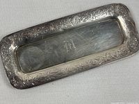Full view of rectangular sterling silver butter dish showing floral border and monogram