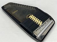 Full view of autoharp front showing strings, chord bars and overall condition