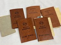 Front view of five Merit Handfile pocket stamp files and one grey file