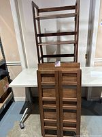 Both folding shelves, one folded flat, one assembled