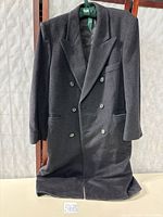 Front view of charcoal grey double-breasted overcoat hanging