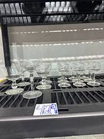 All nine etched crystal stem glasses on shelf