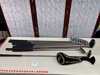 Full set of clubs laid out on table