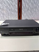 Front view of Hitachi VT-MX4410A 4-head VHS VCR showing control buttons and cassette slot