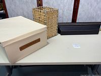 Overall lot showing waste basket, wall shelf, storage box