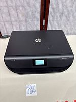 Top view of closed HP Envy 5055 printer showing HP logo and control panel display