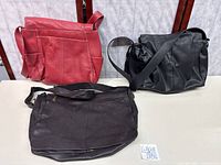 All three bags displayed upright on table