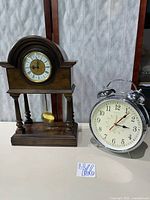 Front view of both clocks: Franz Hermle mantle clock and Sterling & Noble alarm clock