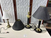 Overview of three lamps and three shades on table