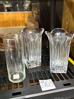 Group shot of two Miller Rogaska SoHo crystal vases and one cylindrical glass vase