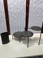 Vase and three-tier plant stand on table