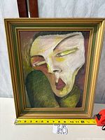 Front view of framed painting with measuring tape for width