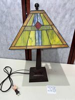 Full view of lamp with stained glass shade and cord