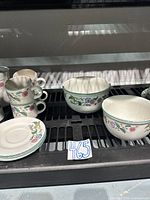 Mix of mugs, saucers and bowls showing Castle Garden pattern