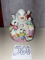 Front view showing Buddha with five children and facial details