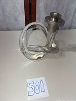 Entire candlestick showing twisted lucite body and metal cup