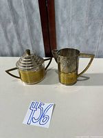 Creamer and covered sugar bowl side by side showing overall design