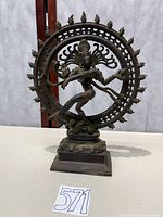 Full view of brass Shiva Nataraja statue on table showing size and overall form