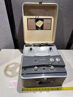 Recorder with lid open showing control panel and manual in lid