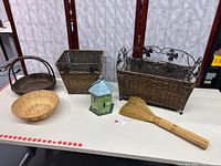Group shot of all four wicker baskets, birdhouse and broom
