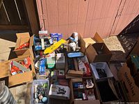 Overview of multiple boxes with assorted auto parts and tools