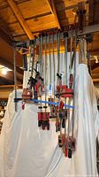 Full view of assorted Bessey and Jorgensen clamps hanging