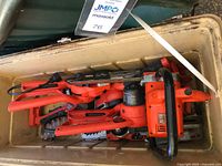 Five Black & Decker Alligator loppers and one additional chainsaw stored in cooler