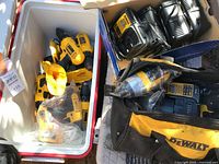 Cooler and bag containing multiple DeWalt cordless drills, impact drivers, hammer drill and chargers